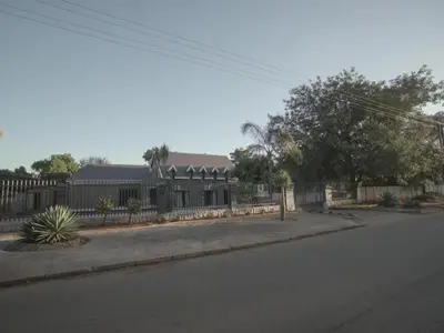 a building with a fence on the side of a street at Insolam Accommodation in Mokopane