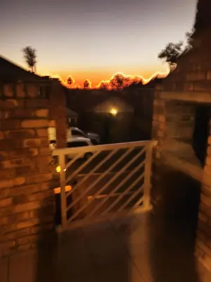 a view of a wooden gate with the sunset in the background at Centurion villa in Centurion