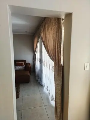 a hallway with a window and a couch at Centurion villa in Centurion