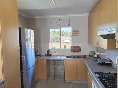 a kitchen with a stainless steel refrigerator and a sink at Centurion villa in Centurion