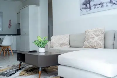 a living room with a white couch and a coffee table at Homeaway in Midrand