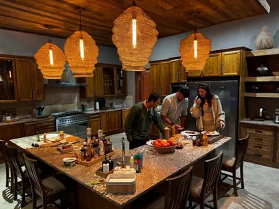 a group of three people preparing food in a kitchen at RoiSan Private Game Lodge in Rooiberg