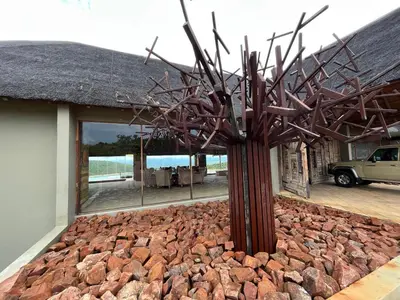 a sculpture of a tree in front of a building at RoiSan Private Game Lodge in Rooiberg