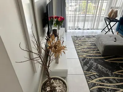 a living room with a vase of flowers on the floor at regal retreat in the blyde in Pretoria
