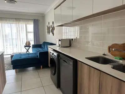 a kitchen with a sink and a dishwasher at regal retreat in the blyde in Pretoria