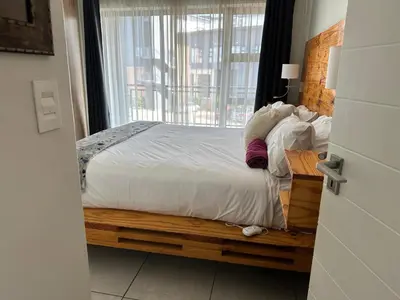 a bedroom with a large bed with a window at regal retreat in the blyde in Pretoria