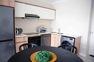 a kitchen with a table with a green bowl on it at regal retreat in the blyde in Pretoria