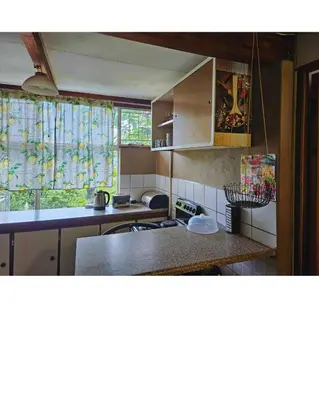 a kitchen with a counter top and a window at Cottage of the Grumpy Old Man, no loadshedding in Pretoria