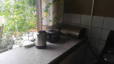 a coffeemaker on a kitchen counter with a window at Cottage of the Grumpy Old Man, no loadshedding in Pretoria