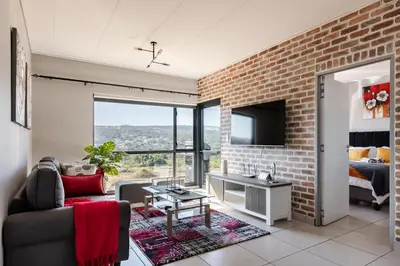 a living room with a brick wall at Lowveld Getaway in Nelspruit
