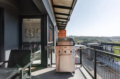 a grill on the balcony of a house at Lowveld Getaway in Nelspruit