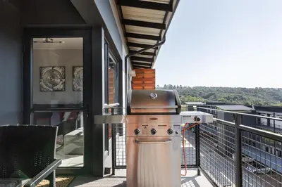 a grill on the balcony of a house at Lowveld Getaway in Nelspruit