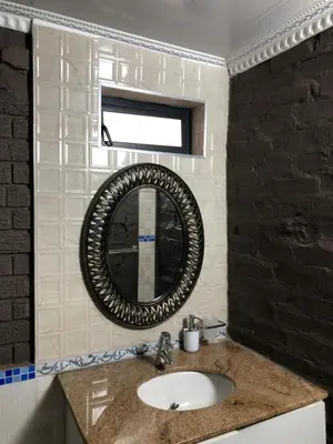 a bathroom with a sink and a mirror at Urban Space Lodge in Pretoria
