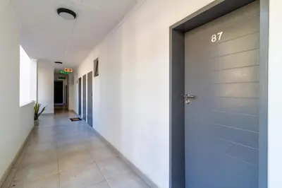 a hallway with a blue door in a building at First Floor 2 Beds Premium Suite in Midrand