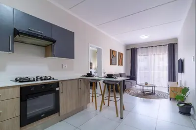 a kitchen with a stove and a counter top at First Floor 2 Beds Premium Suite in Midrand