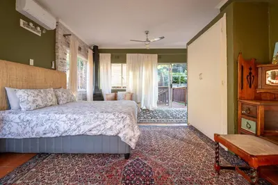 a bedroom with a bed and a living room at 59 Kiepersol in Kampersrus AH