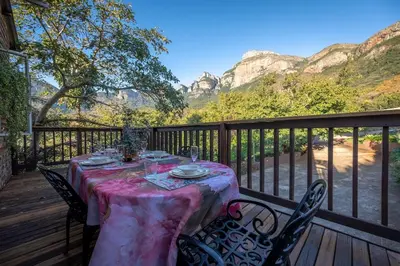 a table on a deck with a view of mountains at 59 Kiepersol in Kampersrus AH