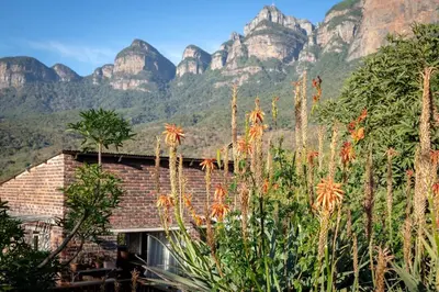 a building with mountains in the background at 59 Kiepersol in Kampersrus AH