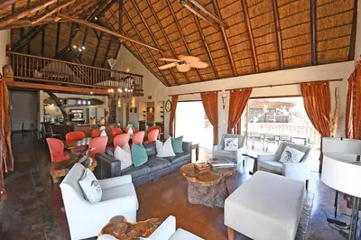 a living room with couches and chairs in a building at Damani Lodge at Zebula Golf Estate and Spa in Warmbaths