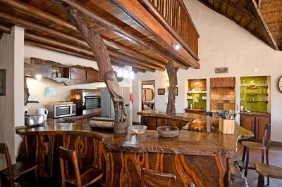 a kitchen with a large wooden island in a room at Damani Lodge at Zebula Golf Estate and Spa in Warmbaths