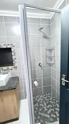 a bathroom with a shower and a sink at Amani Place Midrand in Midrand