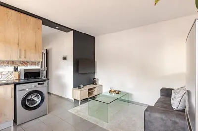 a living room with a washing machine and a couch at Amani Place Midrand in Midrand