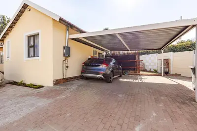 a car parked in a garage next to a house at Amani Place Midrand in Midrand