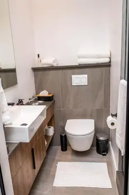 a bathroom with a white toilet and a sink at Triple M Luxury in Vosburg