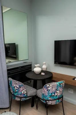a room with two chairs and a table and a tv at Triple M Luxury in Vosburg