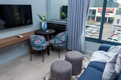a living room with a couch and chairs and a table at Triple M Luxury in Vosburg