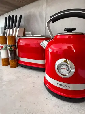 two red toasters are sitting next to some knives at Dung Beetle Bush Villa in Marloth Park