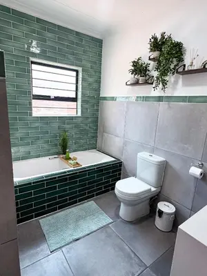 a bathroom with a tub and a toilet and a sink at Dung Beetle Bush Villa in Marloth Park