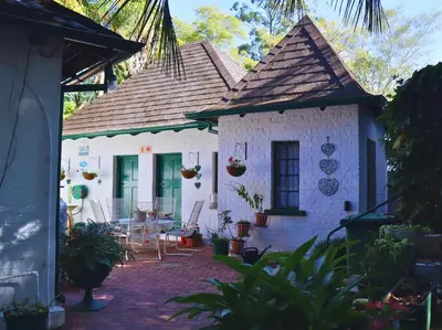 a small white house with a table and chairs at Glory Hill Lodge in White River