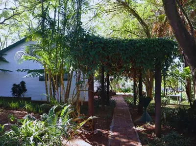 a garden with a brick path in front of a house at Glory Hill Lodge in White River