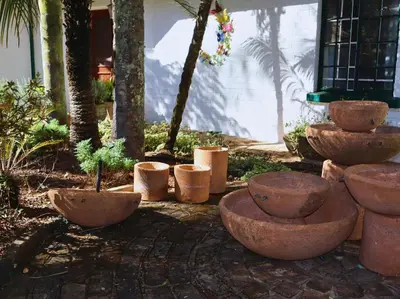 a group of large stone bowls and plants in a yard at Glory Hill Lodge in White River