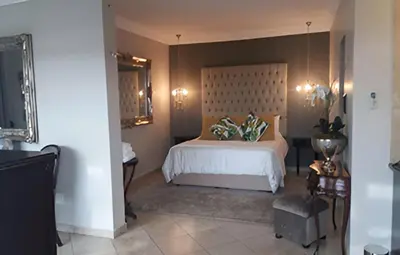 a bedroom with a bed with a headboard at Destiny Lodge Cullinan in Cullinan