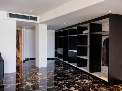 a room with a large closet with black shelves at Pent Lucius - 3 bedroom Penthouse in Pretoria
