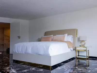a bedroom with a large white bed with pink pillows at Pent Lucius - 3 bedroom Penthouse in Pretoria