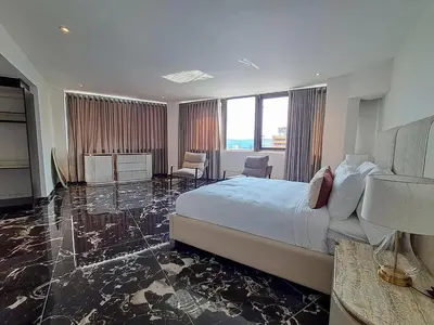 a large hotel room with a bed and a large window at Pent Lucius - 3 bedroom Penthouse in Pretoria