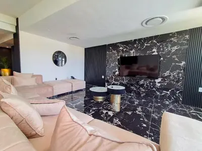 a living room with couches and a flat screen tv at Pent Lucius - 3 bedroom Penthouse in Pretoria