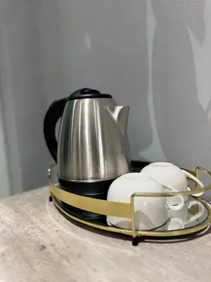 a tea kettle on a tray next to two mouses at Glowti Guest House in Centurion
