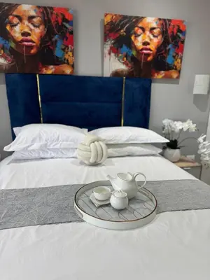 a tray with a tea set on a bed at Glowti Guest House in Centurion