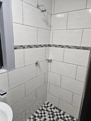 a bathroom with a shower with a toilet and a sink at Beautiful apartment in Witbank