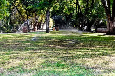 a park with a water fountain in the grass at Twin Bed Room in Steelpoort