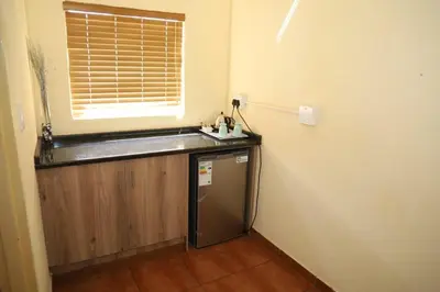 a small kitchen with a counter and a window at Twin Bed Room in Steelpoort