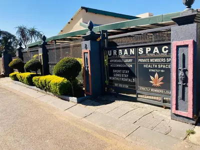 a fence with a sign in front of a building at Urban Space in Pretoria