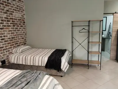 a room with two beds and a brick wall at Duikertjie in Groblersdal
