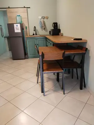 a kitchen with a table and chairs and a refrigerator at Duikertjie in Groblersdal