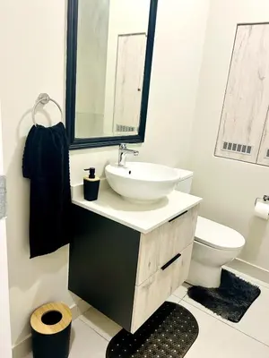 a bathroom with a sink and a toilet at Cozy Carlswald EXcape in Midrand