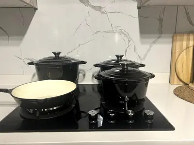 a stove with three pots and a pan on it at Cozy Carlswald EXcape in Midrand